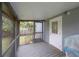 Spacious screened porch with wood flooring, open views and access to a backyard at 311 W Chelsea St, Tampa, FL 33603