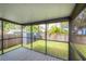 Open screened porch showcasing a view of the lush, fenced backyard with green grass at 311 W Chelsea St, Tampa, FL 33603