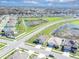 Expansive aerial view of a residential community featuring homes, ponds, and green spaces at 35661 Jenny Lynne Cir, Zephyrhills, FL 33541