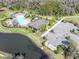 Community pool aerial overlooking lounge chairs, landscaping and parking at 35661 Jenny Lynne Cir, Zephyrhills, FL 33541
