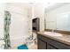 Bathroom with a vanity, framed mirror, and a shower-tub combination with tiled walls at 35661 Jenny Lynne Cir, Zephyrhills, FL 33541