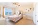 Cozy bedroom with natural light, carpet, and a comfortable bed with views of the outside at 35661 Jenny Lynne Cir, Zephyrhills, FL 33541
