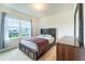 Bright bedroom featuring a bed, neutral walls, carpet and a large window, creating a serene and inviting atmosphere at 35661 Jenny Lynne Cir, Zephyrhills, FL 33541