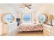 Bedroom with matching dressers with circular mirrors, ceiling fan, and carpet floors at 35661 Jenny Lynne Cir, Zephyrhills, FL 33541