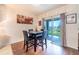 Cozy dining area with wood floors, a modern table set, and a sliding glass door leading to the backyard at 35661 Jenny Lynne Cir, Zephyrhills, FL 33541