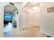 Hallway featuring an arched doorway leading to a living space with tile floors and neutral wall colors at 35661 Jenny Lynne Cir, Zephyrhills, FL 33541