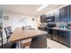 Kitchen island with counter seating, dark cabinetry, and tile backsplash, ideal for casual dining and meal prep at 35661 Jenny Lynne Cir, Zephyrhills, FL 33541
