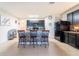 Kitchen island with bar seating complemented by dark cabinets and modern appliances, perfect for entertaining at 35661 Jenny Lynne Cir, Zephyrhills, FL 33541