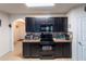 Kitchen boasting dark cabinetry, granite countertops, and modern appliances for a sleek, functional design at 35661 Jenny Lynne Cir, Zephyrhills, FL 33541