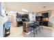 Spacious kitchen featuring a center island with seating, dark cabinets, and tile flooring throughout at 35661 Jenny Lynne Cir, Zephyrhills, FL 33541