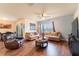 Comfortable living room with hardwood floors, a brown leather recliner, and two sofas, creating a cozy atmosphere at 35661 Jenny Lynne Cir, Zephyrhills, FL 33541