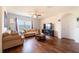 Inviting living room with hardwood floors, comfortable seating, and a large window overlooking the outside view at 35661 Jenny Lynne Cir, Zephyrhills, FL 33541