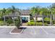 Clubhouse with outdoor pool area, surrounded by lush landscaping and ample parking at 35661 Jenny Lynne Cir, Zephyrhills, FL 33541