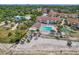 Overhead view of a community with a pool, beach, kayaks, and well-kept buildings surrounded by lush trees at 3710 41St S Way # D, St Petersburg, FL 33711