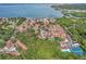 Community aerial view highlighting lush greenery, waterways, and red tiled roofs at 3710 41St S Way # D, St Petersburg, FL 33711