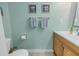 Powder blue bathroom with matching wall decorations, towel rack, and toilet at 3710 41St S Way # D, St Petersburg, FL 33711