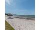 Seaside beach featuring white sand and a thatched umbrella at 3710 41St S Way # D, St Petersburg, FL 33711