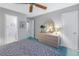 Light bedroom featuring a dresser with round mirror and an open doorway to a bathroom at 3710 41St S Way # D, St Petersburg, FL 33711