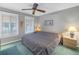 Inviting bedroom with plush carpeting and an ornate patterned bedspread with two windows at 3710 41St S Way # D, St Petersburg, FL 33711
