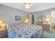 Spacious bedroom with light-colored walls, a large bed, and a dresser with a round mirror at 3710 41St S Way # D, St Petersburg, FL 33711