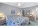 Comfortable bedroom with a bed featuring an ocean themed comforter, dresser, and a ceiling fan at 3710 41St S Way # D, St Petersburg, FL 33711