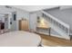 Light-filled dining area featuring a wooden cabinet and a staircase with white railing at 3710 41St S Way # D, St Petersburg, FL 33711