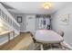 Bright dining room with laminate flooring, a white front door and adjacent staircase at 3710 41St S Way # D, St Petersburg, FL 33711