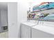 Bright laundry room featuring a washer, dryer, and shelving at 3710 41St S Way # D, St Petersburg, FL 33711