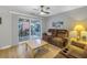 Comfortable living room with a ceiling fan, plush brown reclining sofas, and sliding door to patio at 3710 41St S Way # D, St Petersburg, FL 33711