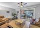 Inviting living room featuring a ceiling fan, comfortable brown sofas, and sliding door to the patio at 3710 41St S Way # D, St Petersburg, FL 33711
