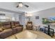 Open-concept living room with kitchen view, comfortable seating, and plenty of natural light at 3710 41St S Way # D, St Petersburg, FL 33711