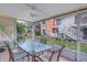 Screened patio with ceiling fan, lights, and glass topped patio table at 3710 41St S Way # D, St Petersburg, FL 33711