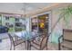 Outdoor patio area with a table, chairs, ceiling fan, and painted mural at 3710 41St S Way # D, St Petersburg, FL 33711
