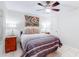 Comfortable bedroom with a ceiling fan, a bed with striped bedding, and unique abstract wall art at 4215 E Bay Dr # 1702F, Clearwater, FL 33764