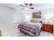 Well-lit bedroom offers tile flooring, natural light, and a ceiling fan for added comfort at 4215 E Bay Dr # 1702F, Clearwater, FL 33764