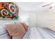 Bedroom with striped bedding and colorful wall art at 4215 E Bay Dr # 1702F, Clearwater, FL 33764