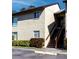 Beige two-story condo building featuring well-maintained landscaping at 4215 E Bay Dr # 1702F, Clearwater, FL 33764