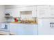 The kitchen featuring white appliances and cabinets at 4215 E Bay Dr # 1702F, Clearwater, FL 33764
