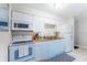 Bright kitchen with white cabinets and appliances at 4215 E Bay Dr # 1702F, Clearwater, FL 33764