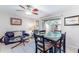Bright living area featuring a dining table and black leather couch at 4215 E Bay Dr # 1702F, Clearwater, FL 33764