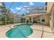 Backyard pool with screen enclosure and covered patio, perfect for outdoor entertaining and relaxation at 4243 Tremblay Way, Palm Harbor, FL 34685