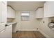 Bright laundry room features ample counter space, storage cabinets, and modern flooring at 4408 W Varn Ave, Tampa, FL 33616