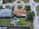 Aerial view of a home featuring a pool, fenced yard, and circular brick driveway at 4581 21St N Ave, St Petersburg, FL 33713