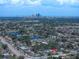 Wide aerial view showing the neighborhood, lake, and cityscape near the house with a pool at 4581 21St N Ave, St Petersburg, FL 33713