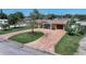 Aerial view of a single-story home featuring a brick driveway, well-manicured lawn, and mature trees at 4581 21St N Ave, St Petersburg, FL 33713