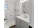 This renovated bathroom has stylish marble tiling in the shower and grey vanity at 4581 21St N Ave, St Petersburg, FL 33713