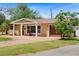 Inviting single-story home featuring a cozy front porch, brick accents, and well-manicured landscaping at 4581 21St N Ave, St Petersburg, FL 33713