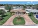 A charming home with a circular brick driveway and well-maintained front yard landscaping at 4581 21St N Ave, St Petersburg, FL 33713