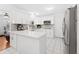 Modern kitchen with stainless steel appliances and white cabinets, complemented by tile flooring and natural light at 4581 21St N Ave, St Petersburg, FL 33713