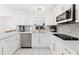 Bright kitchen featuring white cabinetry, stainless steel appliances, and modern countertops, perfect for culinary enthusiasts at 4581 21St N Ave, St Petersburg, FL 33713